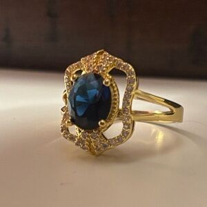 Gold Ring with Deep Blue Oval Stone and Accent Stones